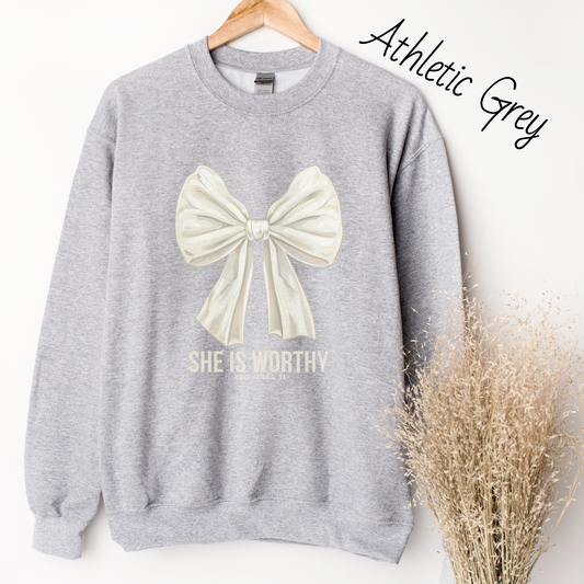Large white bow with the words "She is Worthy Proverbs 31" on a light grey sweatshirt.